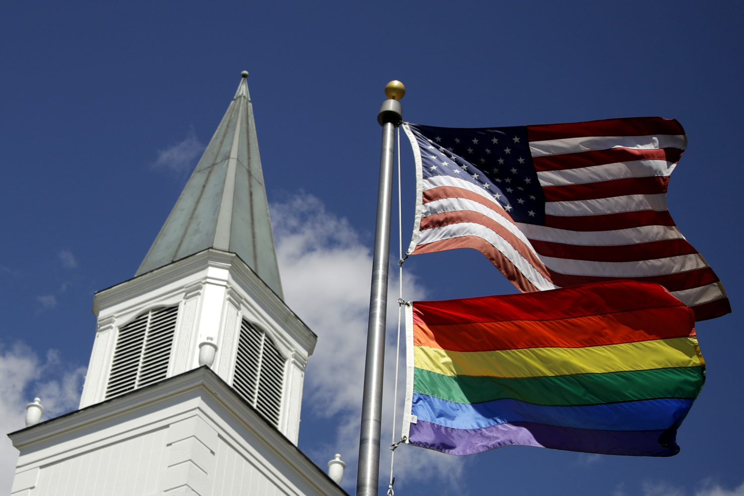 A white church and a pride flag